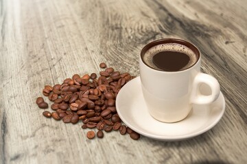 Coffee cup and beans on  desk background