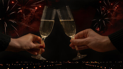 Toast with sparkling wine or champagne glasses on dark black night background - Young woman und man holding glass in the hand