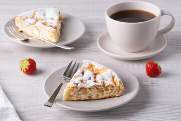 Two delicious pieces of cottage cheese casserole on a light wooden table.
