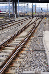Fototapeta premium High angle view of railway track with gravel and concrete railway sleepers at Swiss railway station Zürich Altstetten on an autumn day. Photo taken November 11th, 2024, Zurich, Switzerland.