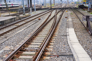 Fototapeta premium High angle view of railway track with gravel and concrete railway sleepers at Swiss railway station Zürich Altstetten on an autumn day. Photo taken November 11th, 2024, Zurich, Switzerland.