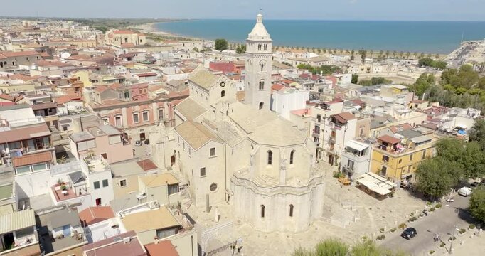 Aerial view of the Basilica of Santa Maria Maggiore in the historic center of Barletta, Puglia, Italy. It is the cathedral and it was built in Romanesque style. In background is the Adriatic sea.