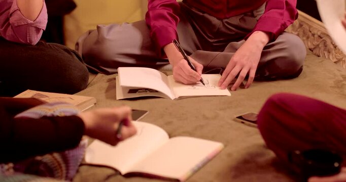 Learning and Skill Sharing: Participants actively take part in creative writing and notetaking activities, all within a relaxed atmosphere. Skill exchange process.