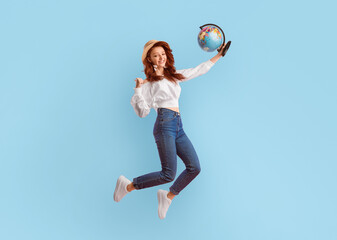 After Quarantine. Happy Traveler Girl Jumping Holding World Globe Gesturing Yes Over Pink Studio...