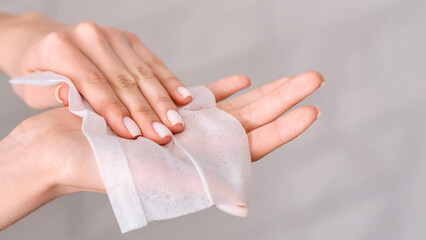 Hygiene during epidemic. Girl wipes hands with antiseptic napkin