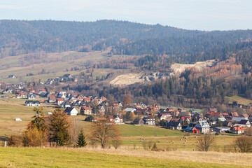 Fototapeta premium Foggy morning in mountainous terrain. Villages in the distance.