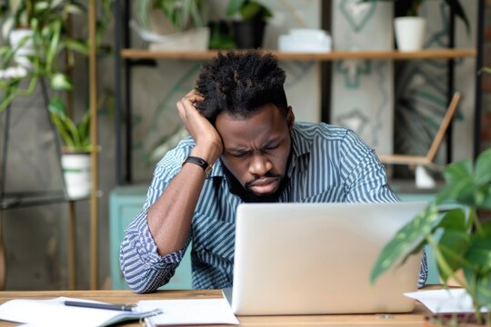 Computer User Black. Overwhelmed African American Businessman at Work Desk, Tired and Exhausted