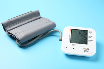 Blood pressure measuring device on light blue background
