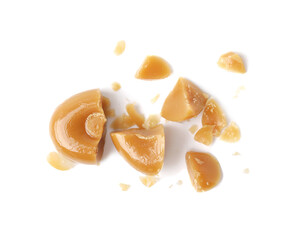 Pieces of tasty hard toffee candy isolated on white, top view