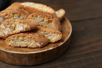 Tasty almond biscuits (Cantuccini) on wooden table, closeup. Space for text