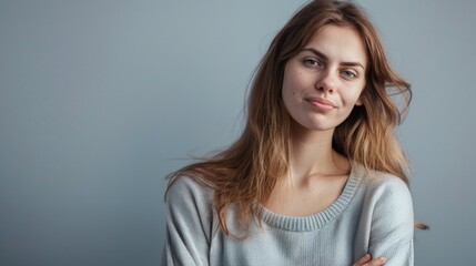 Naklejka premium Mean Person. Young Caucasian Woman in Casual Attire Looking Happy on Gray Background