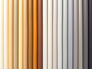 A row of different colored fabric rolls, including tan, brown, and white