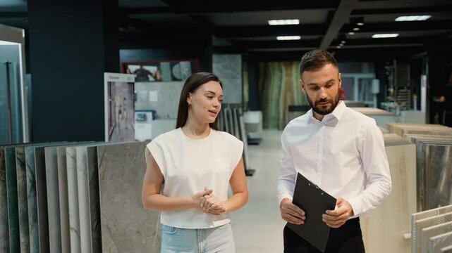 Sales Consultant Assisting Customer in Tile Showroom
