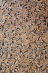 A closeup of a beautifully crafted wooden door with a unique pattern