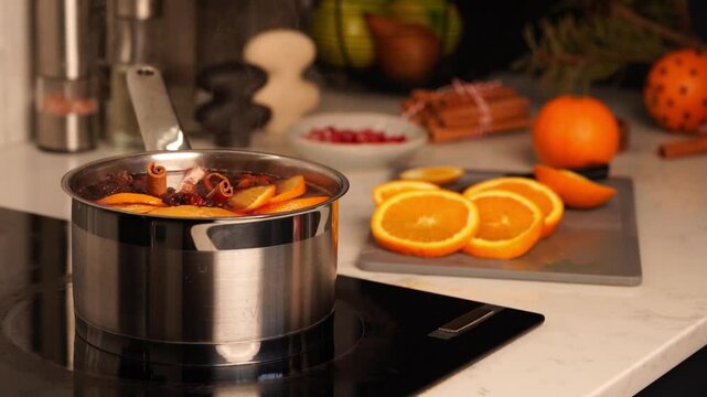 Woman puts Cinnamon into theft with a boiling mullet wine or spiced tea 