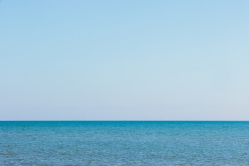The calm, blue waters of Lake Michigan extend to the horizon in early November off the coast of Kohler-Andrae State Park, Sheboygan, Wisconsin