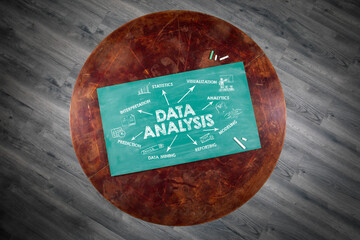 Data Analysis Concept. Illustration with icons, arrows and keywords. Round wooden table