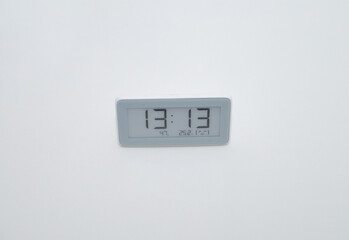 white electronic clock on a white background, time