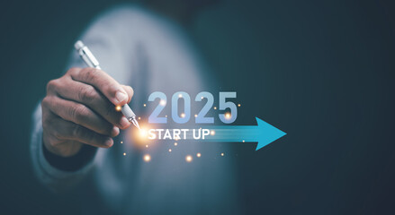 Business start up concept. Businessman using pen pointing at start up new business on 2025. Achieve business planning and start projects for success. Challenge business strategy.