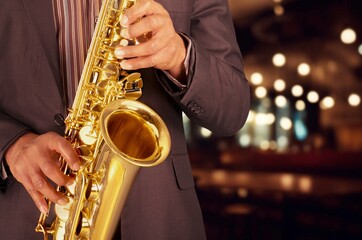 Young jazz musician man playing saxophone