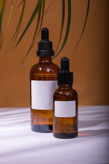 Brown glass bottles with pump of cosmetic products