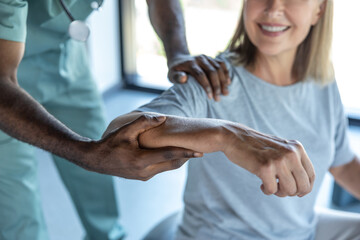 African american doctor working with a female patient in a rehabilitation center