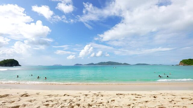 swimmers frolic, swim, play and wade at Nigel's sandy beach on smugglers bay cove on Tortola