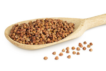 Raw buckwheat in wooden spoon isolated on white background