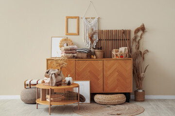 stylish interior of modern room with warm clothes and autumn decor