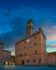 Volterra, medieval palace Palazzo Dei Priori at sunset. Tuscany, Italy