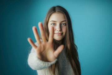 Young woman stands against cyberbullying, calling for online respect, safety, and a stop to harassment. Blue background. Awareness poster.