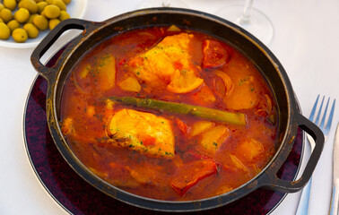 Oven baked merluse with vegetables and tomato sauce