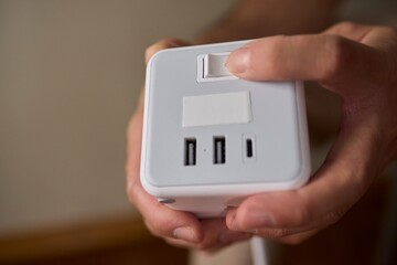 A closeup view of a hand skillfully adjusting a button on a modern, advanced device