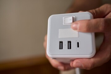 A closeup view of a hand skillfully adjusting a button on a modern, advanced device