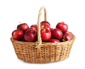 Fresh ripe red apples in wicker basket isolated on white