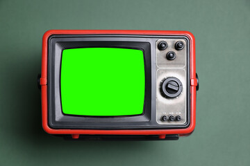 Retro Tv set with green screen on color background. Chroma key