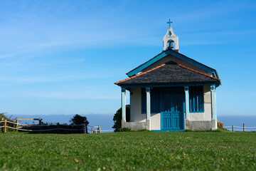 Hermitage of the Regalina with the typical Asturian horreos in Cadavedo, Asturias, Spain