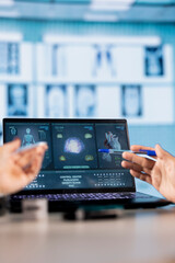 Physician meeting with a patient to discuss medical test results in a cabinet, using advanced diagnostic tools to interpret x ray scans, demonstrating a professional healthcare approach.