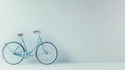 Fototapeta premium A blue bicycle leans against a white wall in a bright room, where the light blue floor reflects its cool hue and the white wall adds to its serene ambiance
