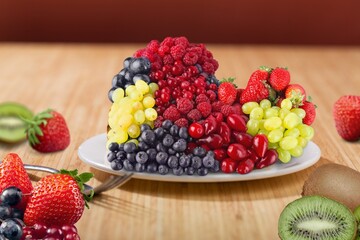 bowl of fresh tasty fruit salad on a wooden table.