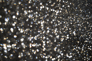 Silver bokeh bright blurred background. Bokeh glitter background. Silver snow bokeh. Silver snow bokeh background. Abstract background with copy space. Holiday backgrounds.