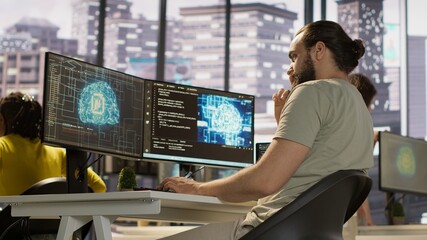 Employee utilizing AI resources and platforms to train and deploy machine learning models, handheld...