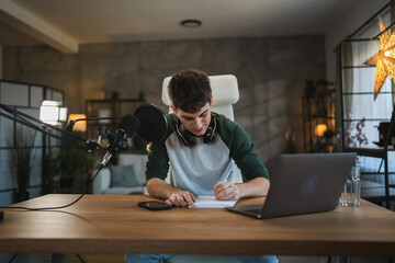 Young man blogger prepare for new video at home studio