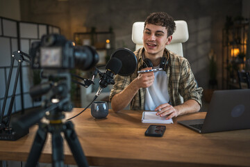 Young man technology blogger record video blog or v-log of new gadget