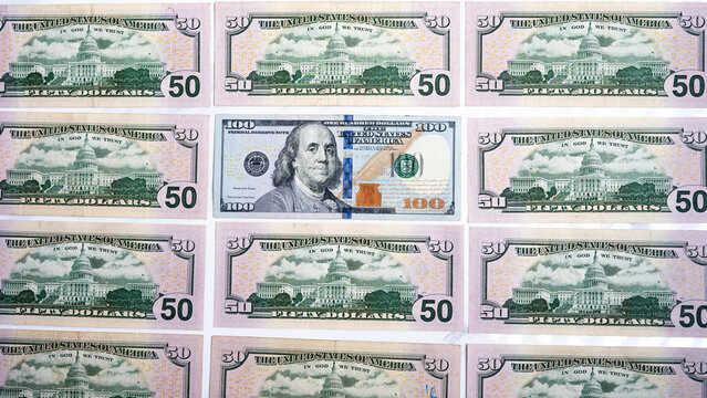 Fifty and hundred dollar bills forming a financial pattern