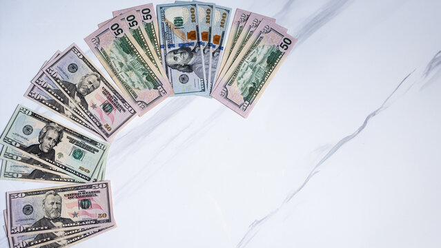 Arrangement of US Dollars on a Marble Surface in a C Shape