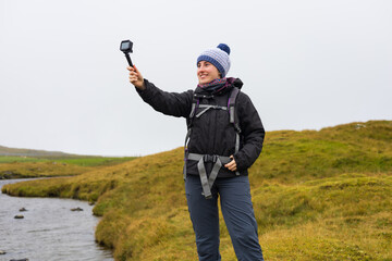 Travel content creator filming landscape vlog in the Faroe Islands