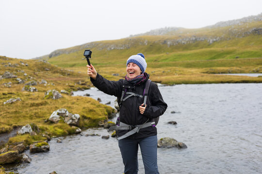 Travel content creator filming landscape vlog in the Faroe Islands