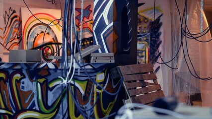 Close up of pizza boxes leftover by teenagers using abandoned building with graffiti drawings to hang out. Desolate defaced location left in messy state by edgy teens, concept of urban culture © DC Studio