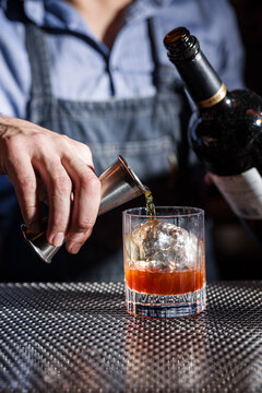 Bartender Crafting Whiskey Old Fashioned with Precision